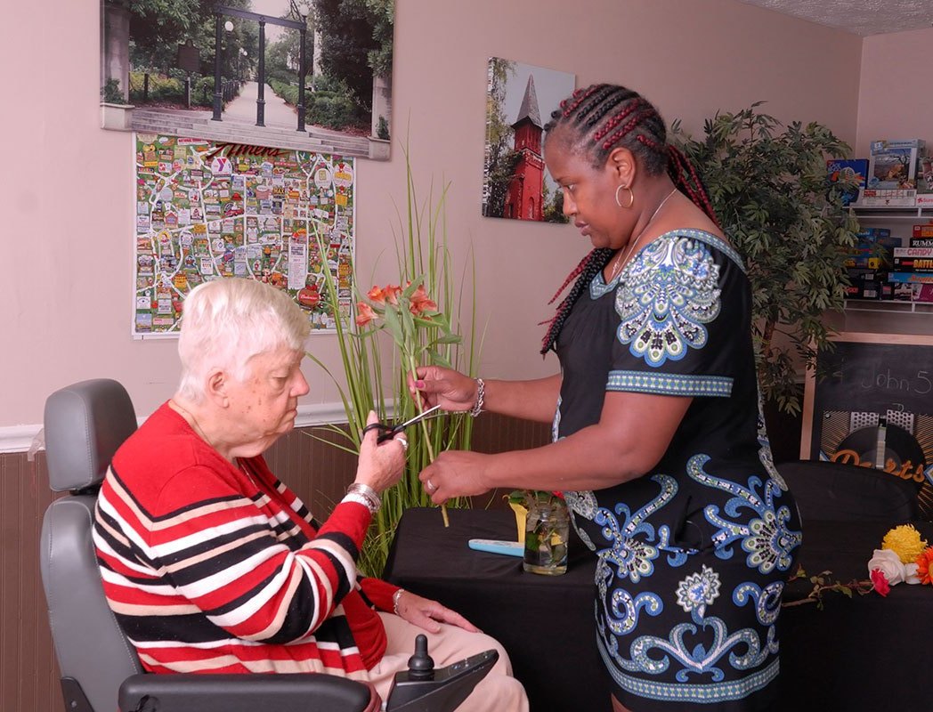 Staff assisting a resident with an activity.
