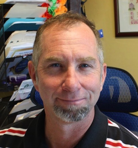 Staff member smiling at the camera.