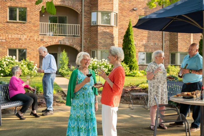 Residents enjoying food and drinks in a garden setting