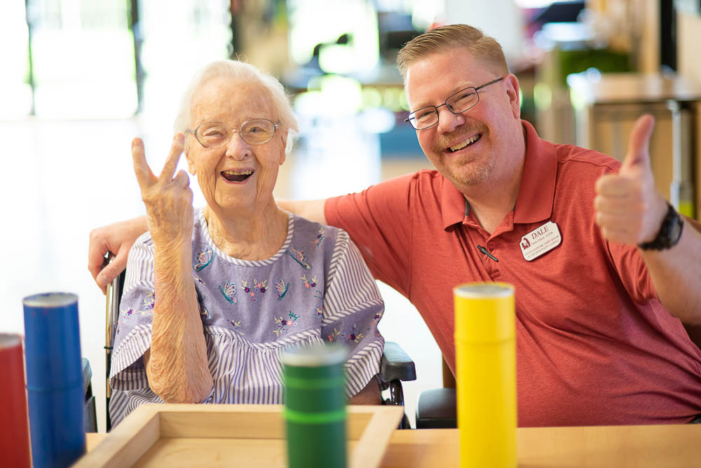 Resident and staff member enjoying an activity together