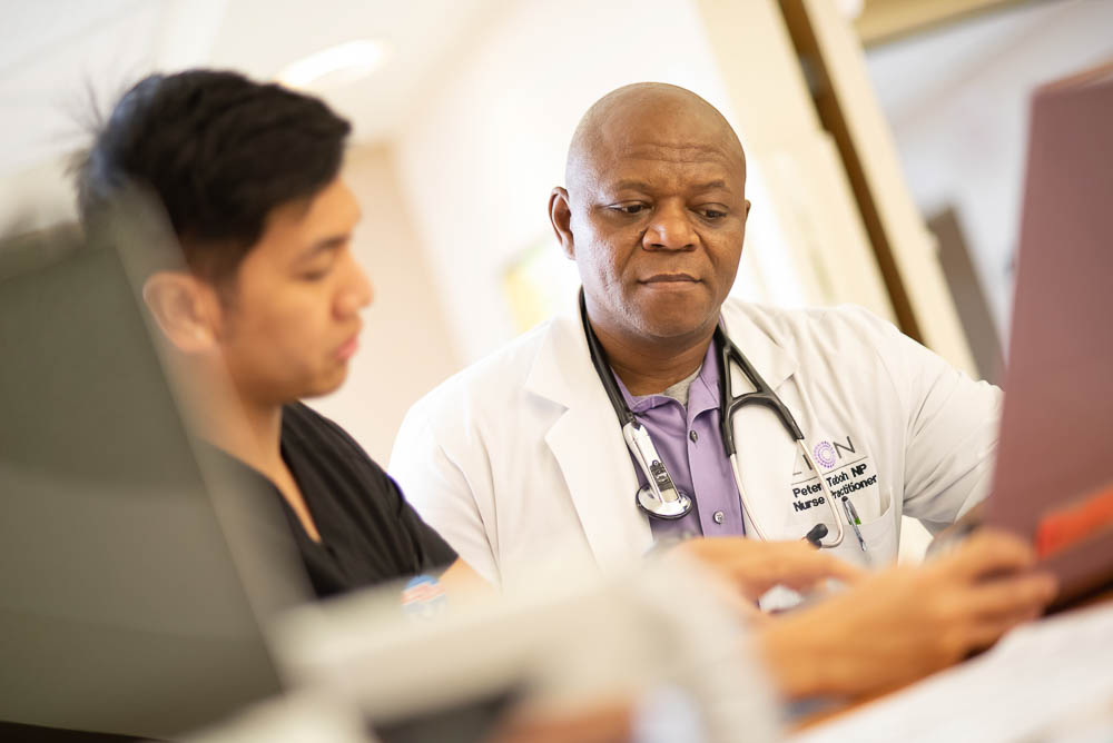 A doctor discussing with a nurse in a healthcare setting