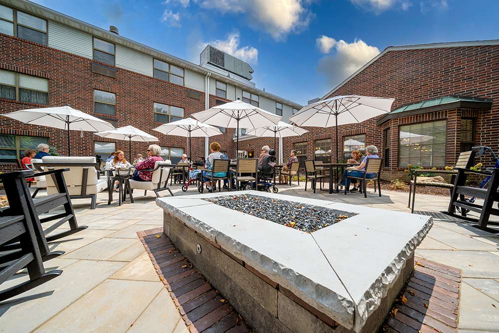Residents enjoying the outdoor patio with umbrellas