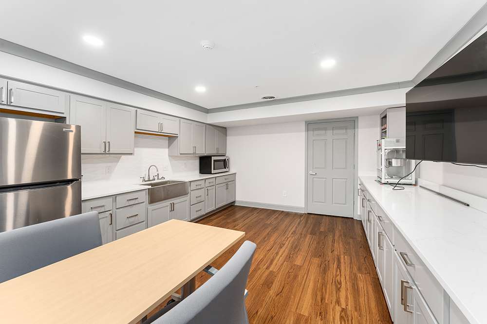 Modern kitchen space with wooden flooring and appliances