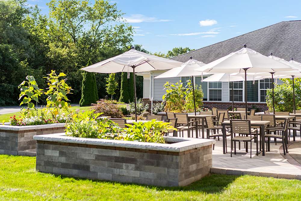 Outdoor seating area with umbrellas and gardens