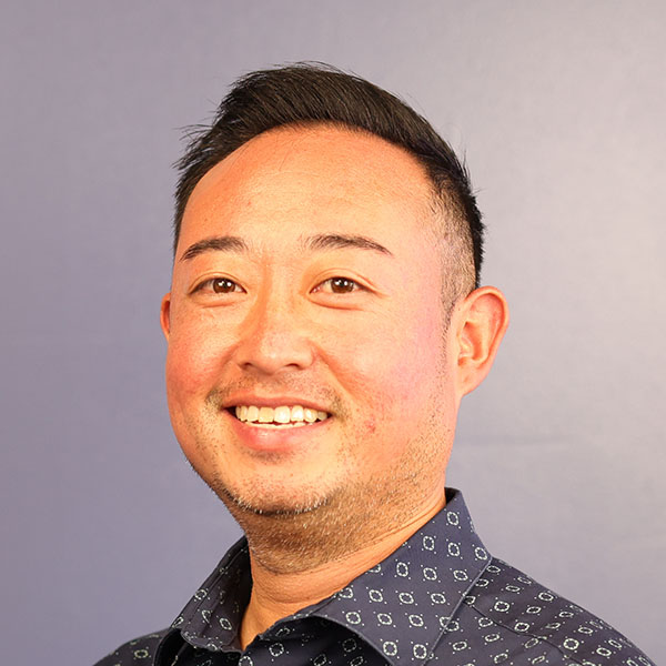 Portrait of a smiling man in a patterned shirt