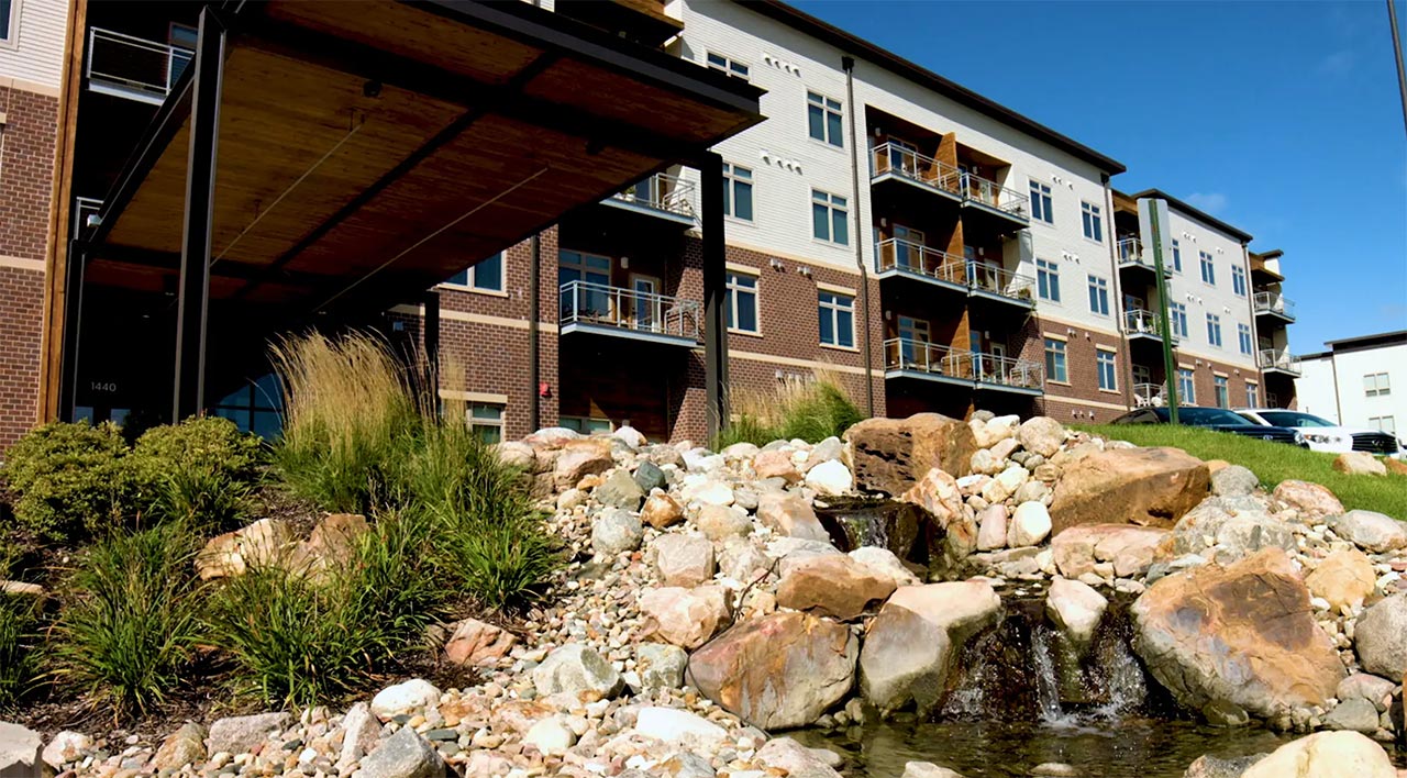 Exterior view of Woodlands Creek Senior Living with landscaping
