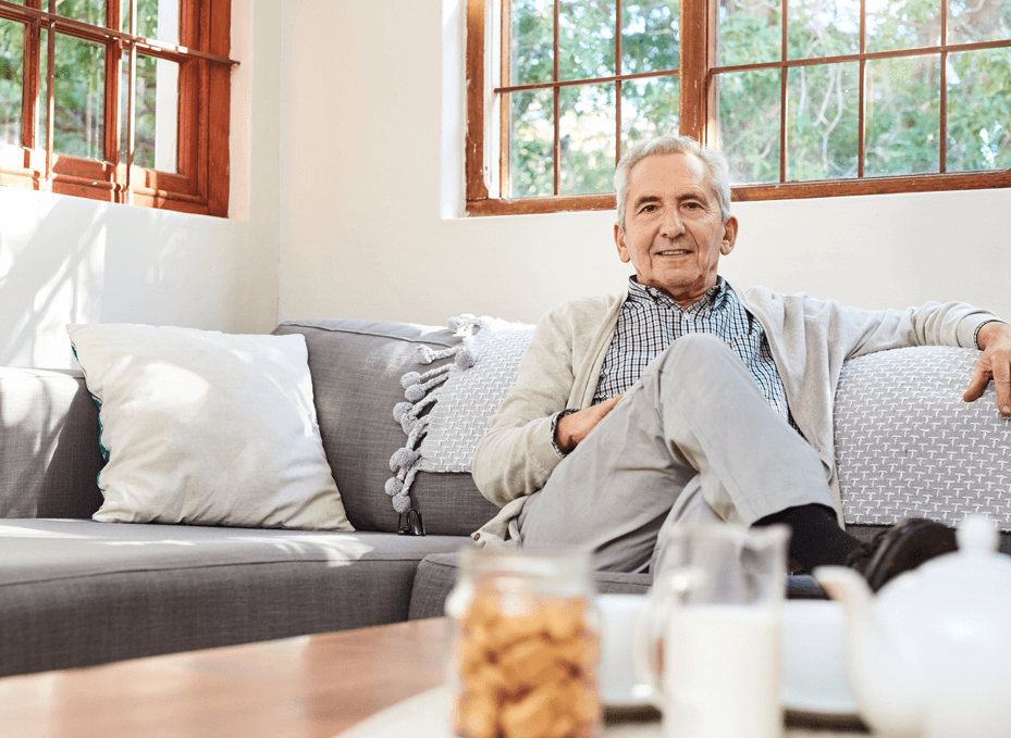 Senior man relaxing on a couch in a bright room