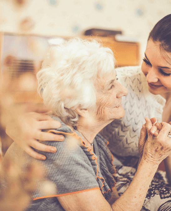 A caregiver interacting with an elderly resident