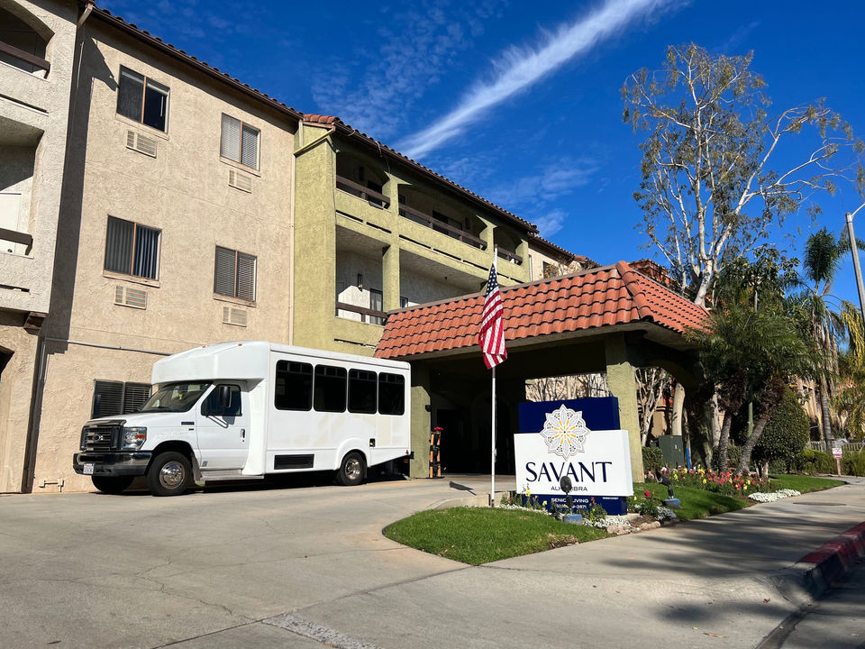 Exterior view of the facility with logo and transportation vehicle