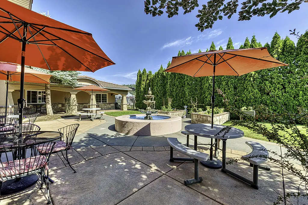 Garden area with tables and red umbrellas