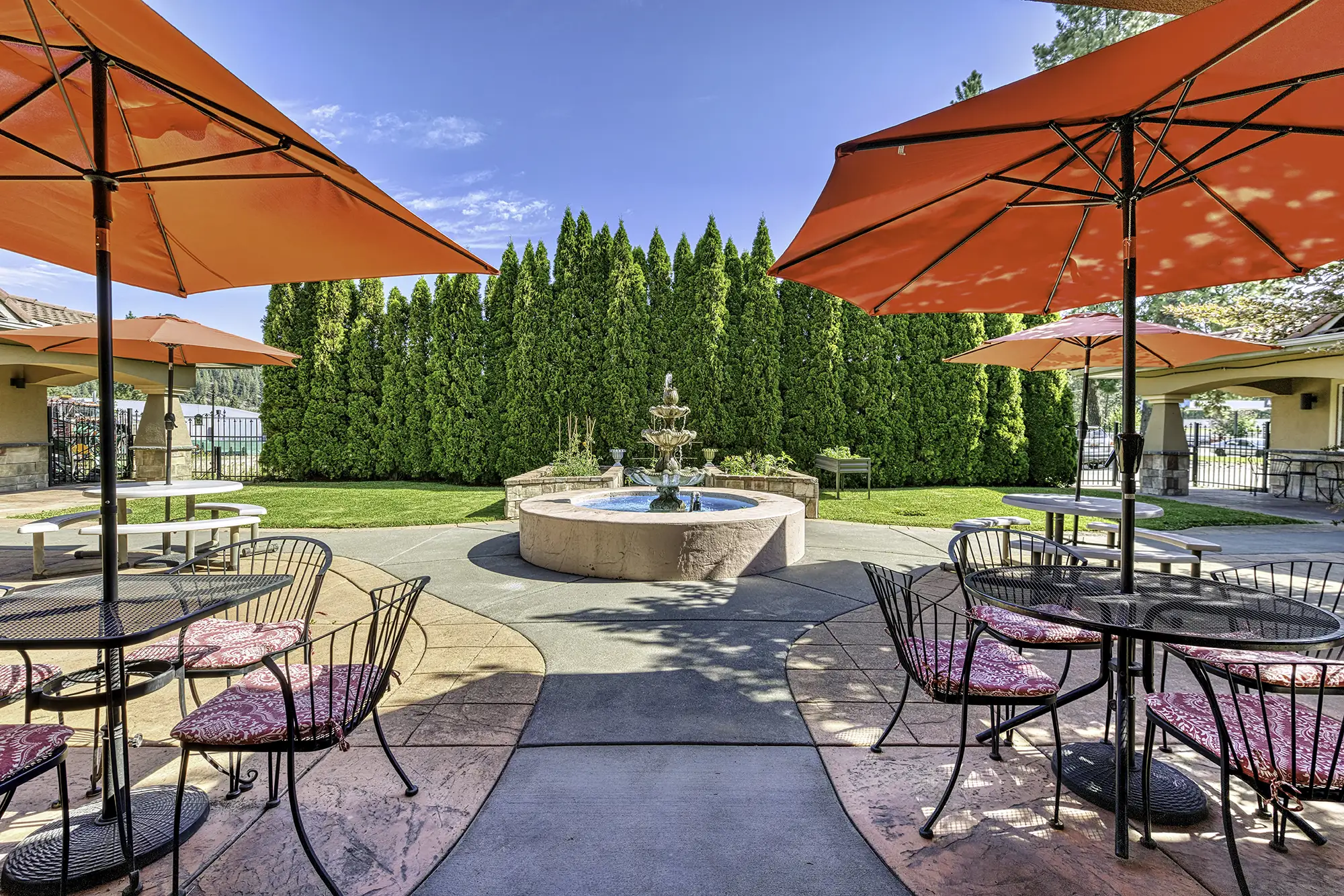 Outdoor seating area with umbrellas and fountain