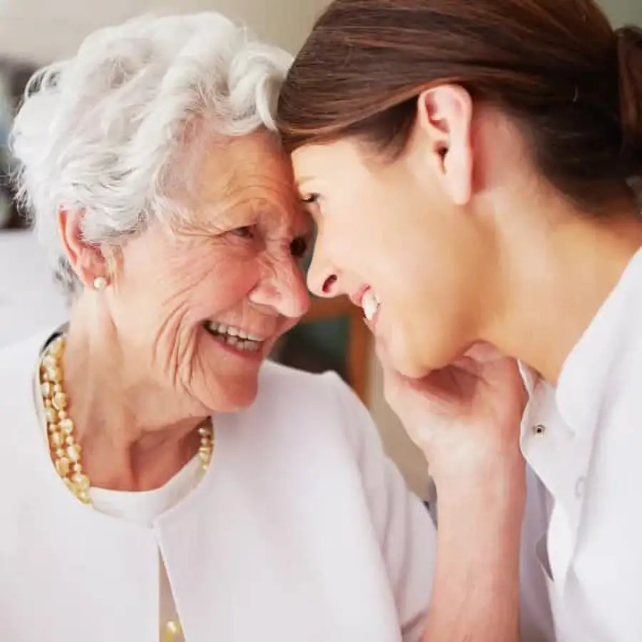 Caregiver and resident sharing a joyful moment