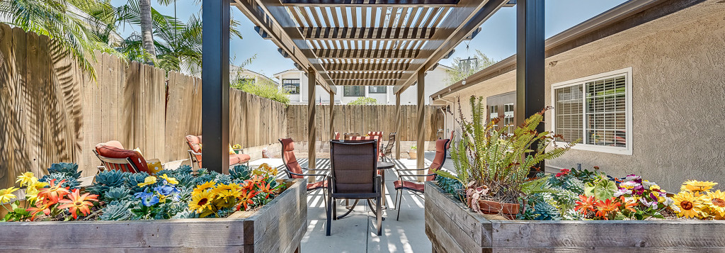 Outdoor patio with flowers and seating area