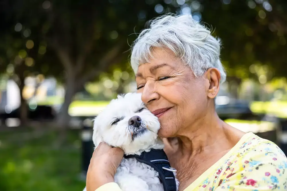 Senior woman enjoying time with a dog in the park