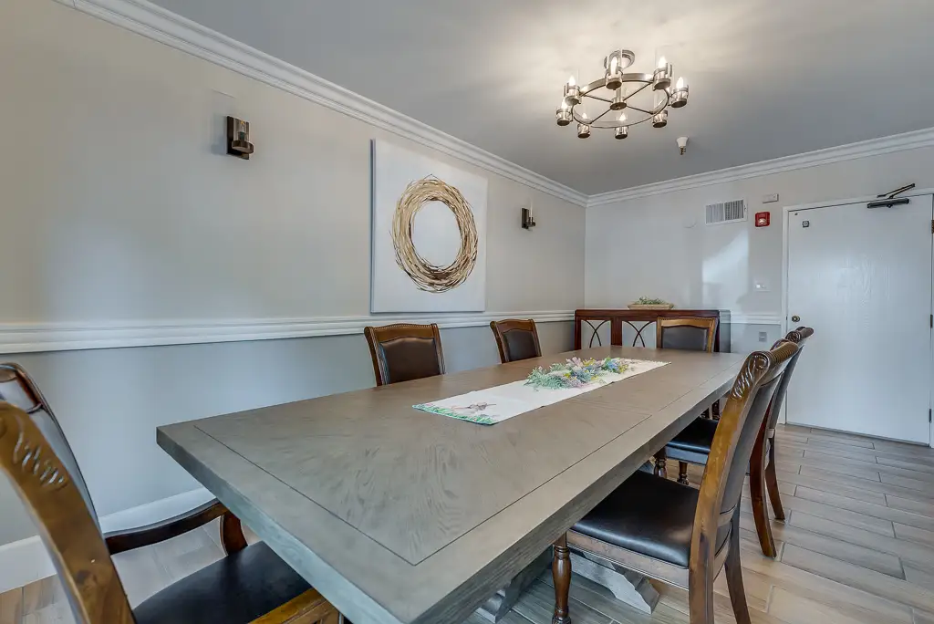 Dining area with a large wooden table and stylish decor