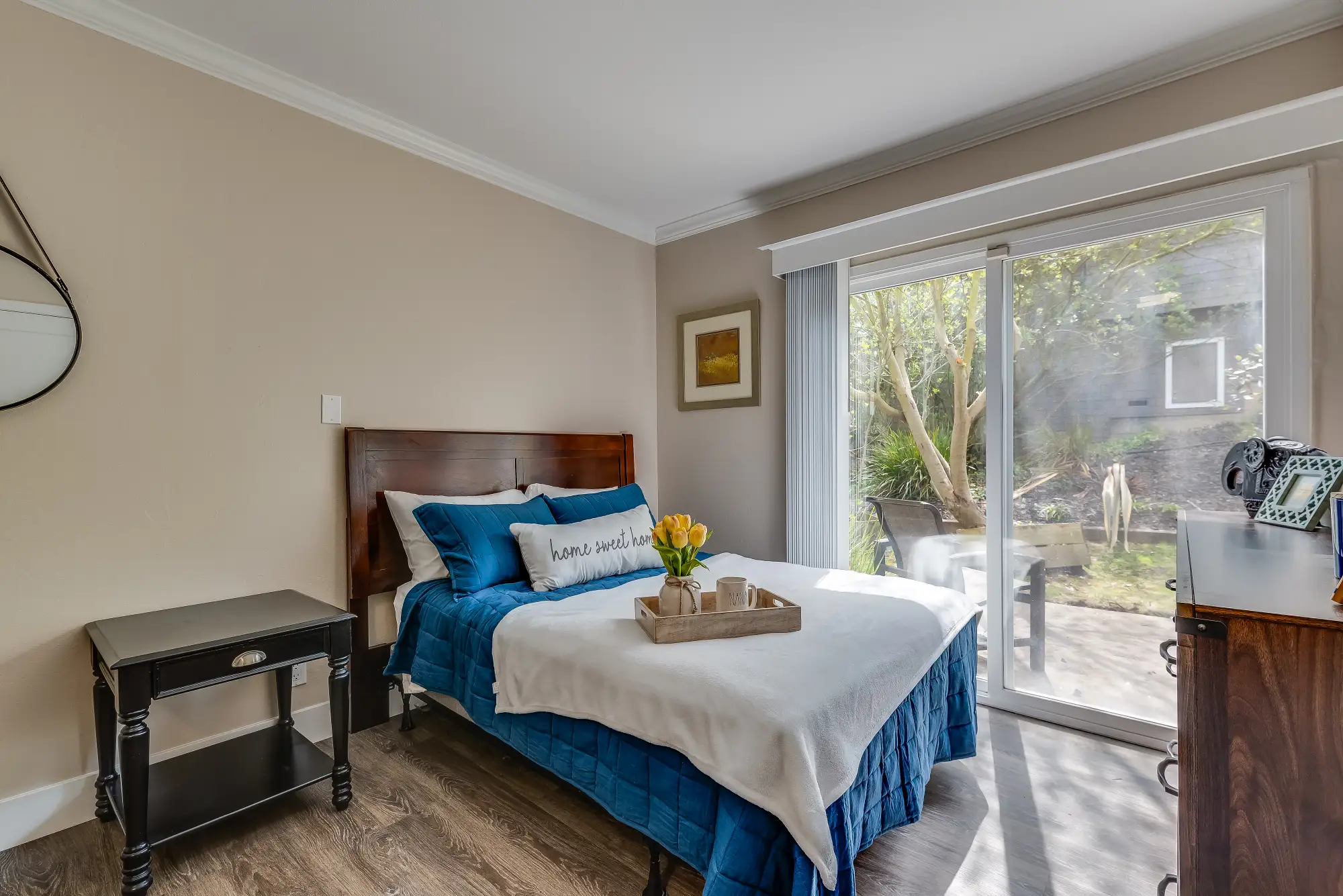 View of a cozy resident room with a bed and garden access