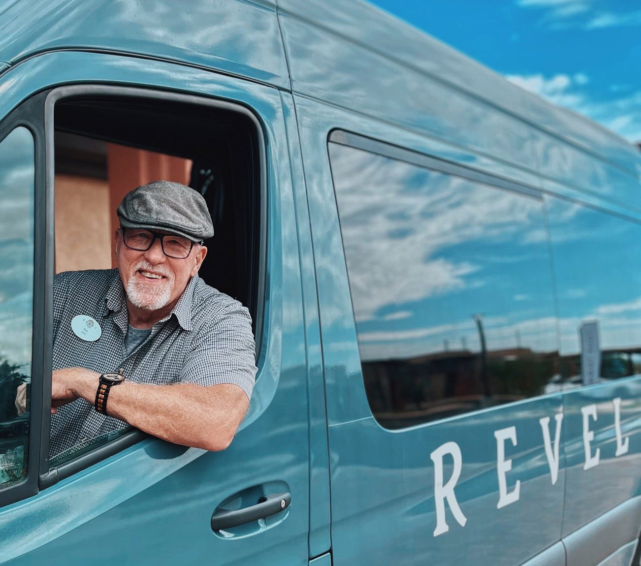 Staff member in van with Revel Legacy branding