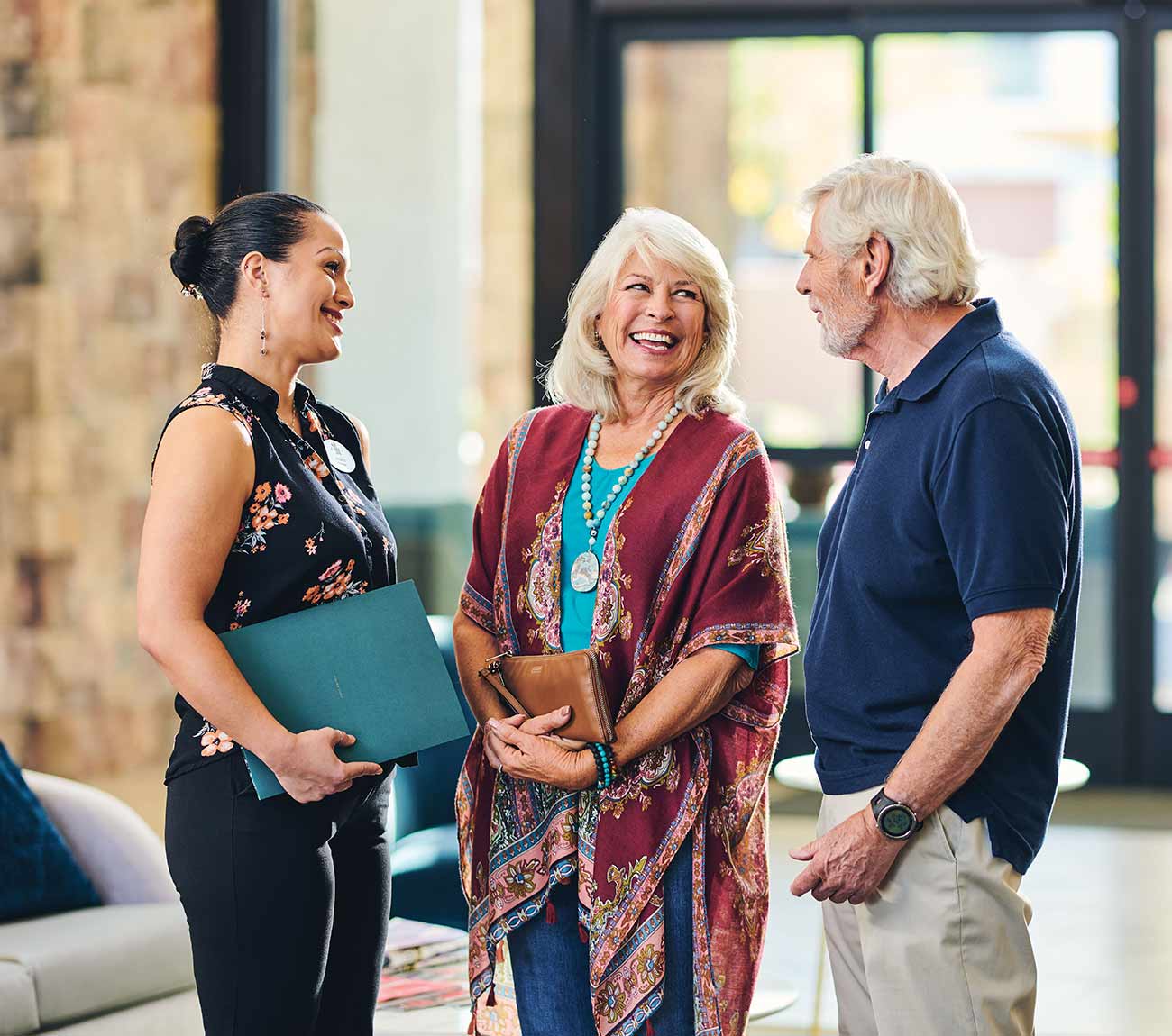 Residents and staff engaging in a cheerful conversation