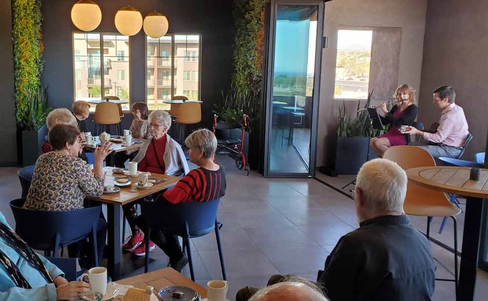 Residents enjoying a musical performance in a common area