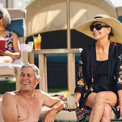 Residents enjoying a poolside day with drinks