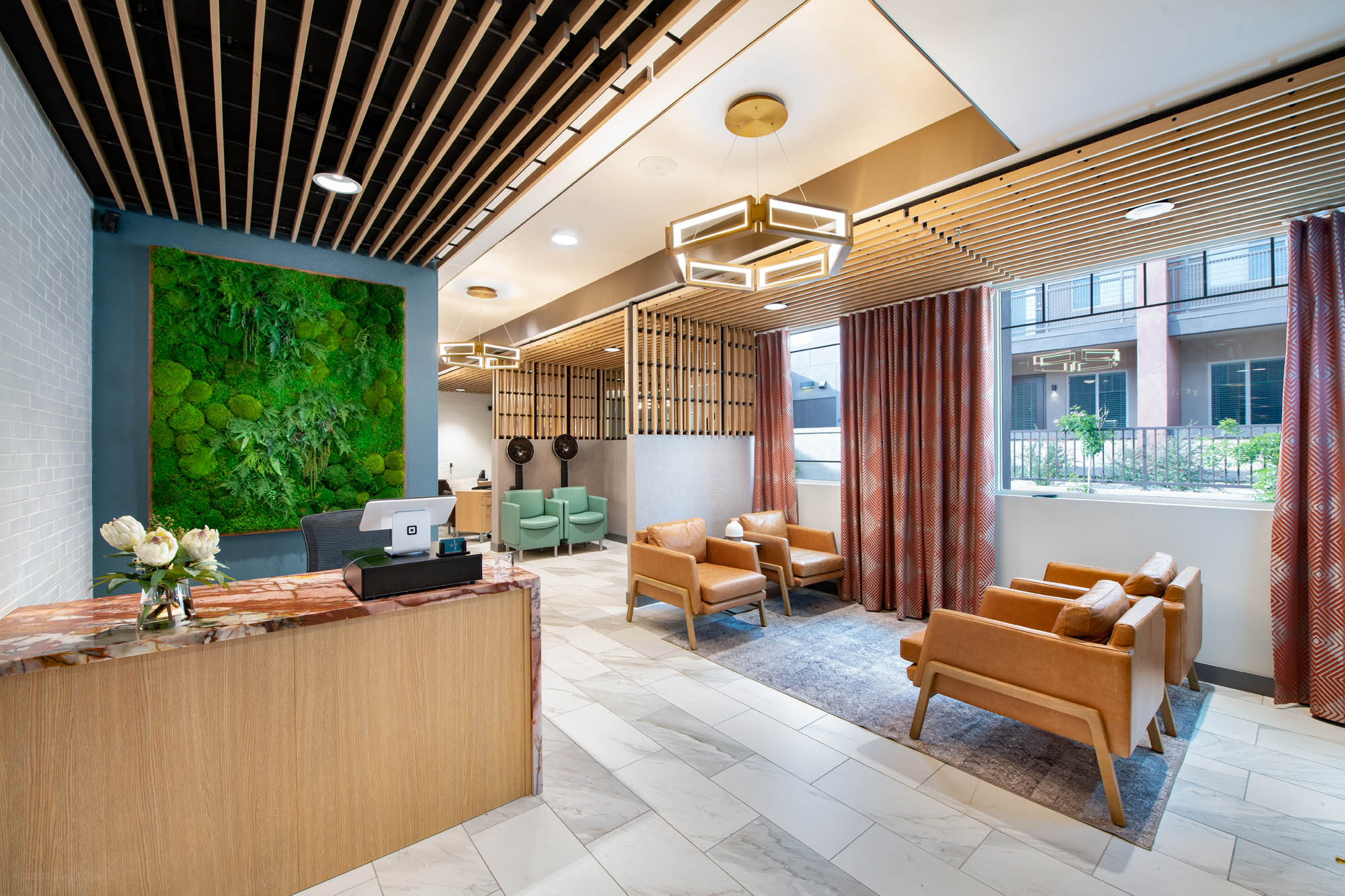 Modern lobby area with seating and greenery