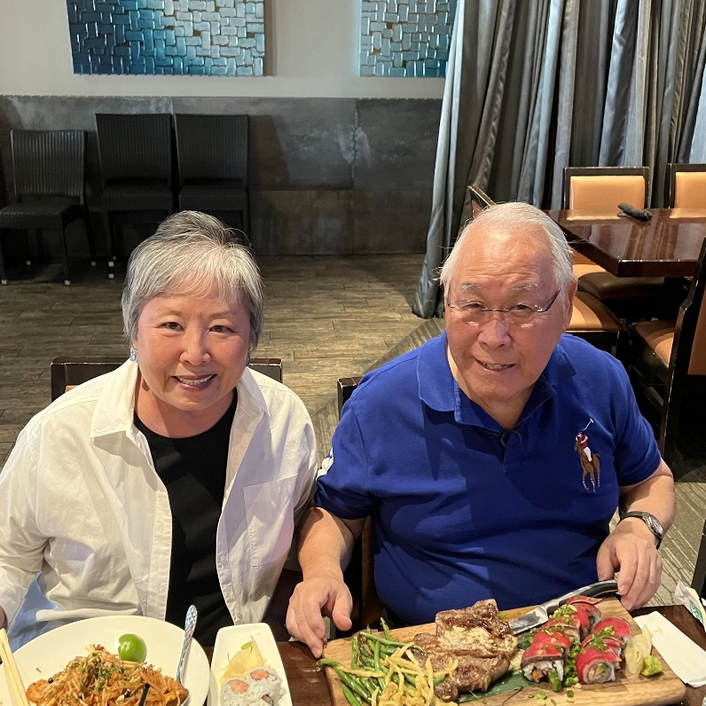 Two residents enjoying a meal together in a dining area