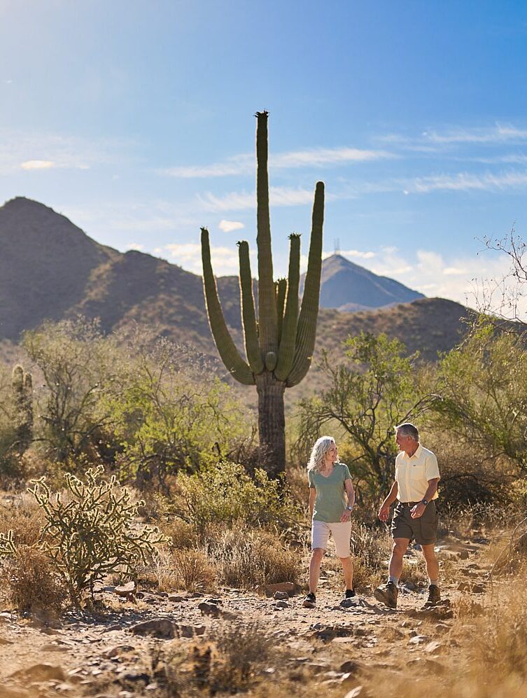 Two seniors enjoying a walk in a desert landscape