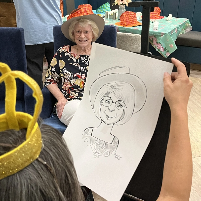 Resident enjoying a caricature drawing activity