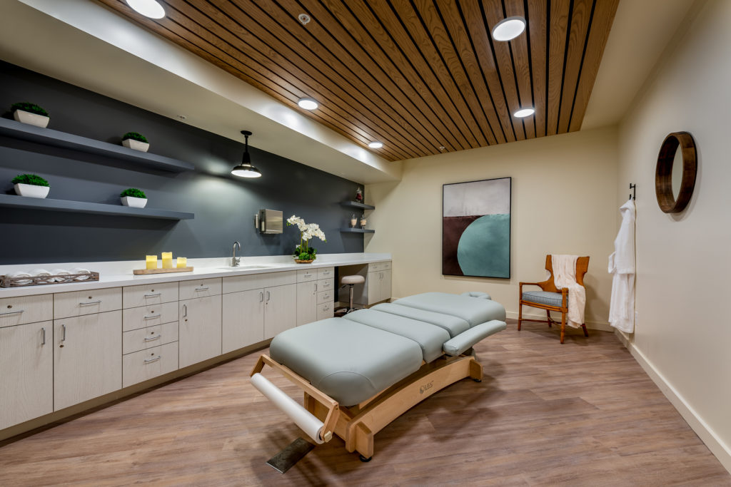 Therapy room with massage table and amenities