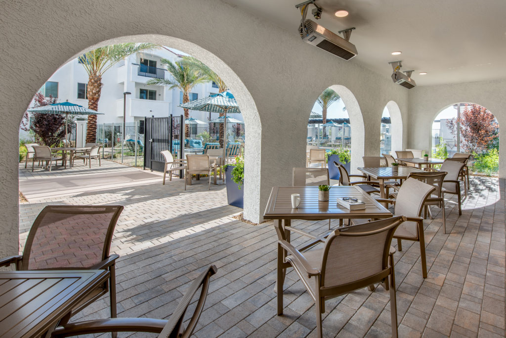 Outdoor seating area with tables and umbrellas
