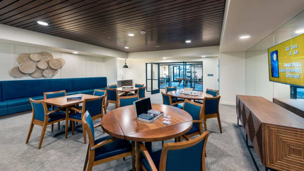 Modern common area with tables and chairs for residents