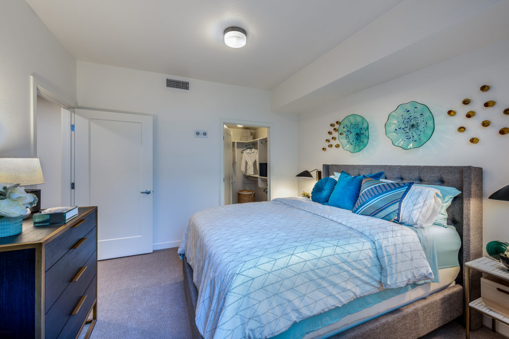 A well-decorated resident room with a cozy bed