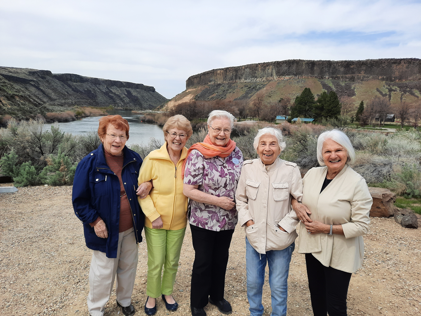 Seniors enjoying an outdoor gathering near a river