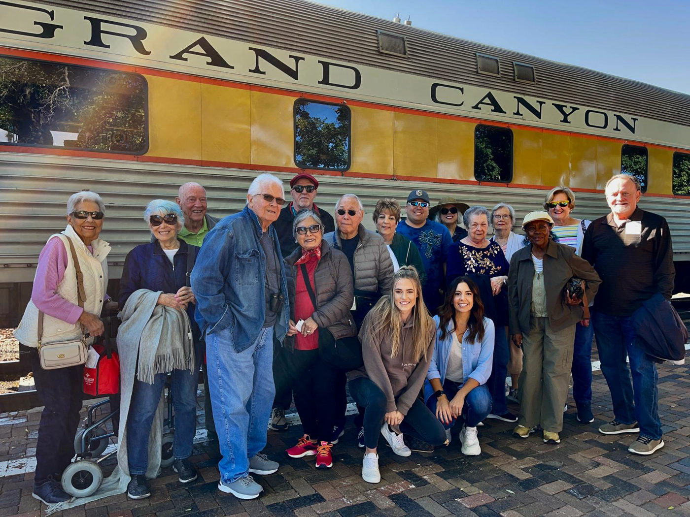Group of residents posing near a train