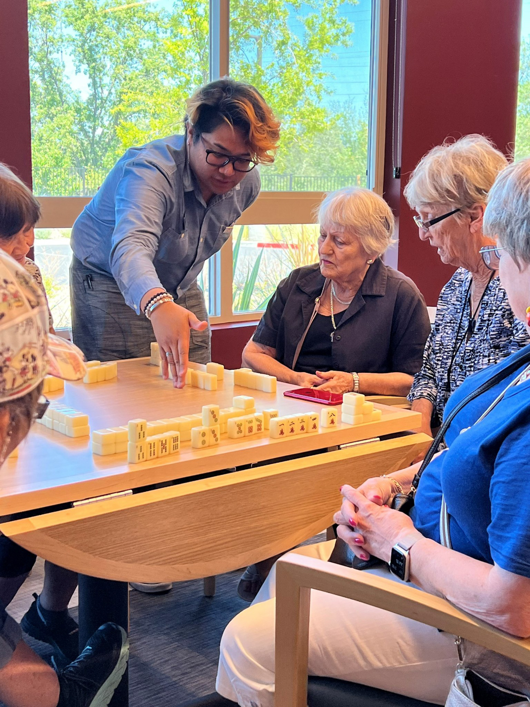 Residents enjoying a game of dominoes in a social activity room
