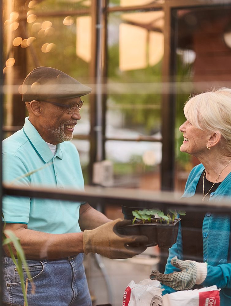 Residents gardening together in a greenhouse