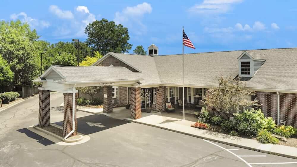 Front entrance of the assisted living facility with flag