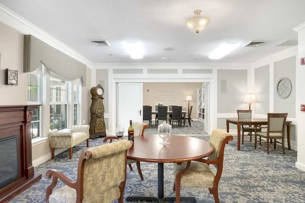 Bright common area with seating and a clock