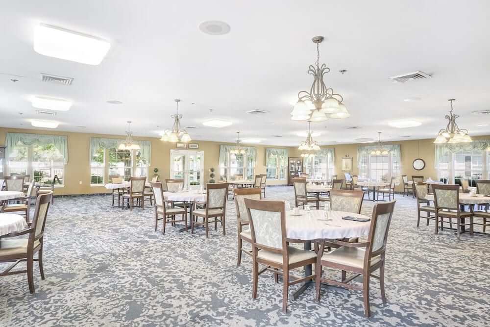 Bright and spacious dining room with tables and chairs