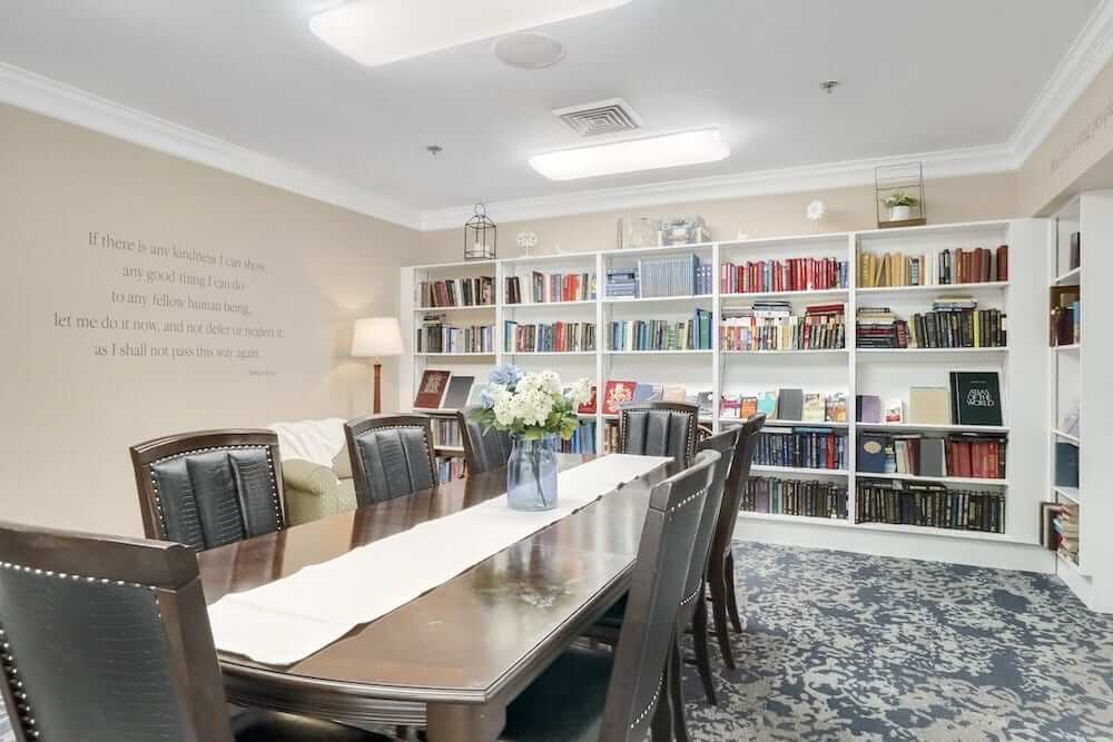 Interior view of a library with bookshelves and a table