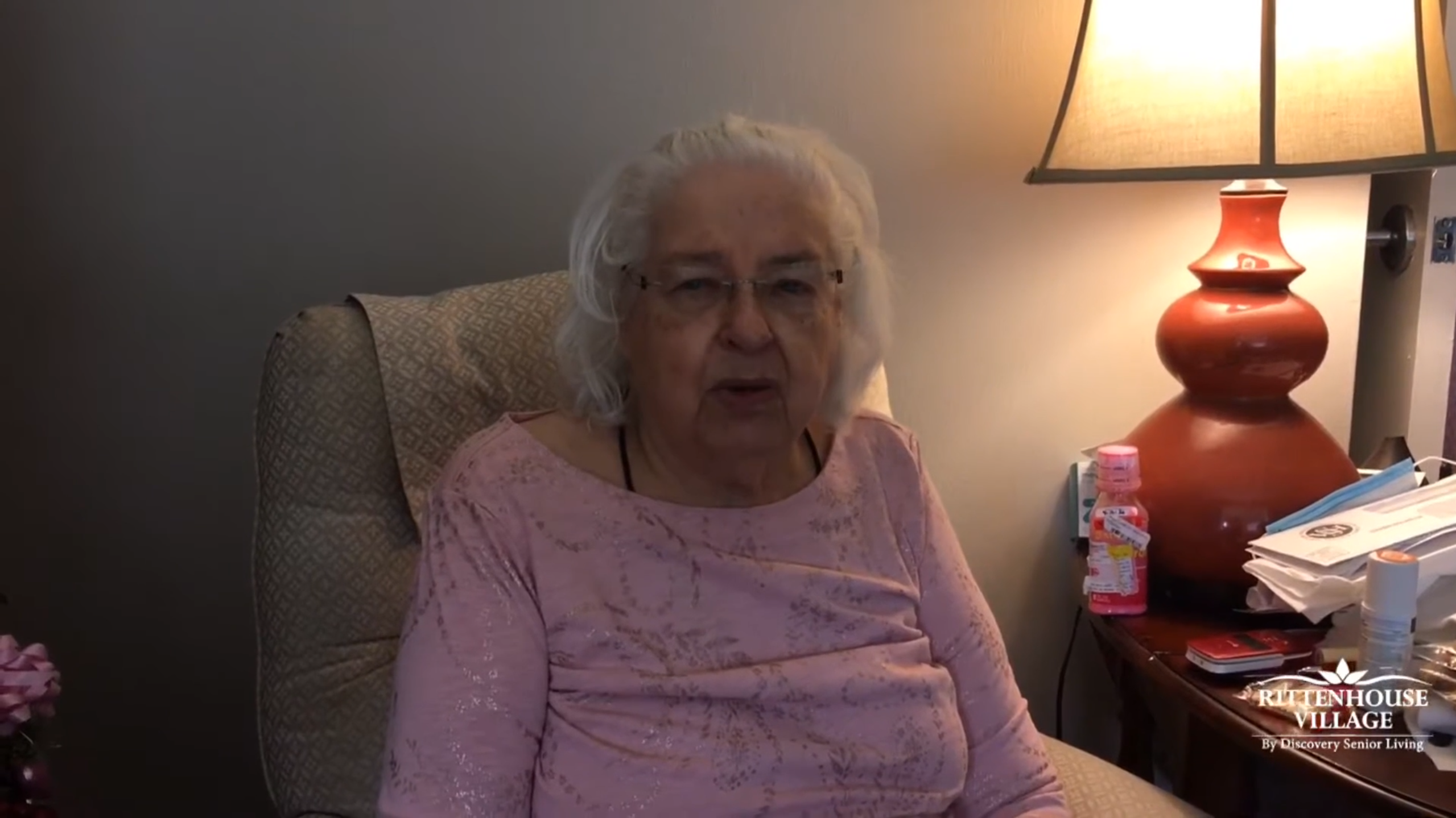 A senior resident sitting in a cozy chair