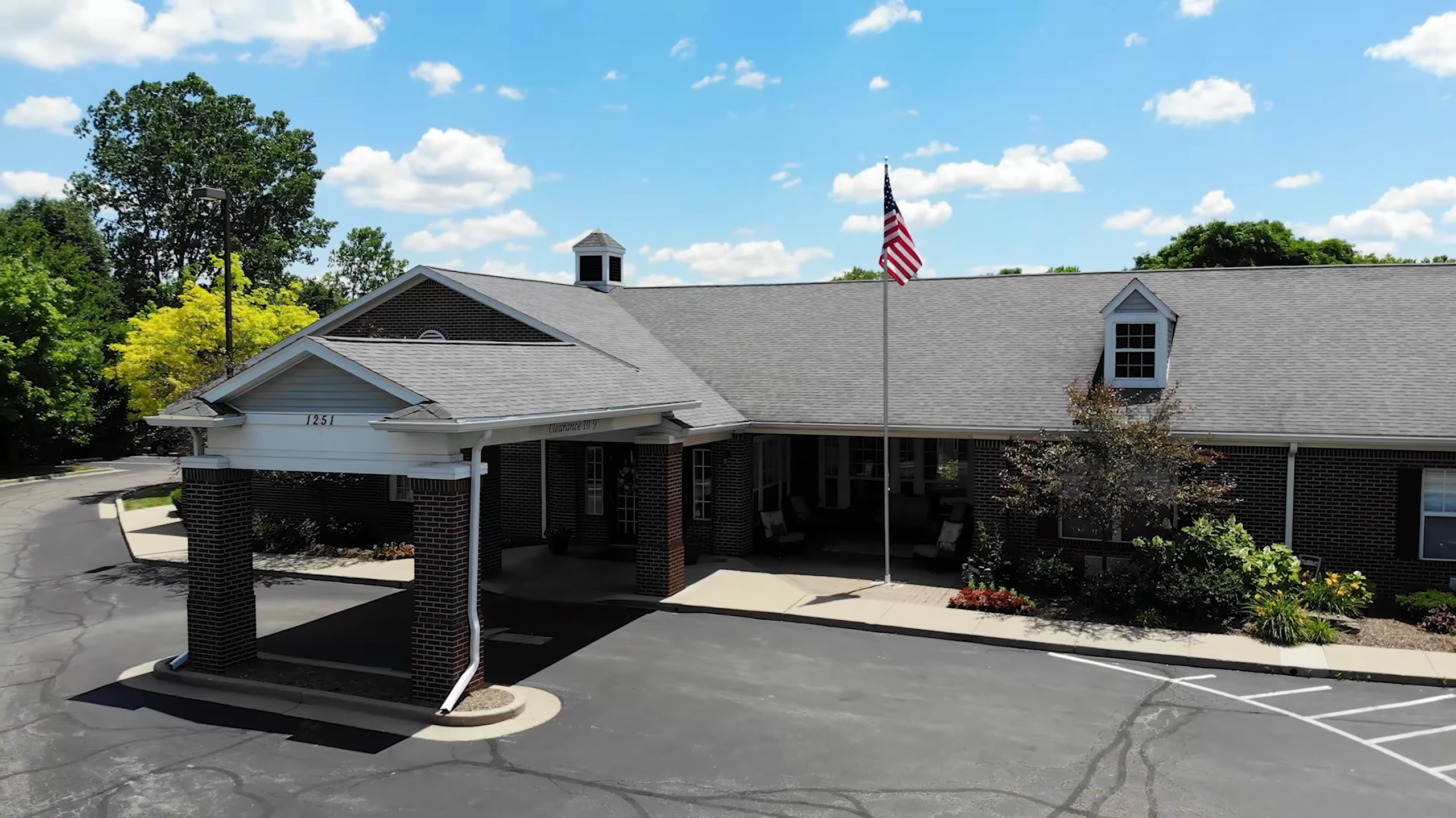 Aerial view of the facility entrance with flag