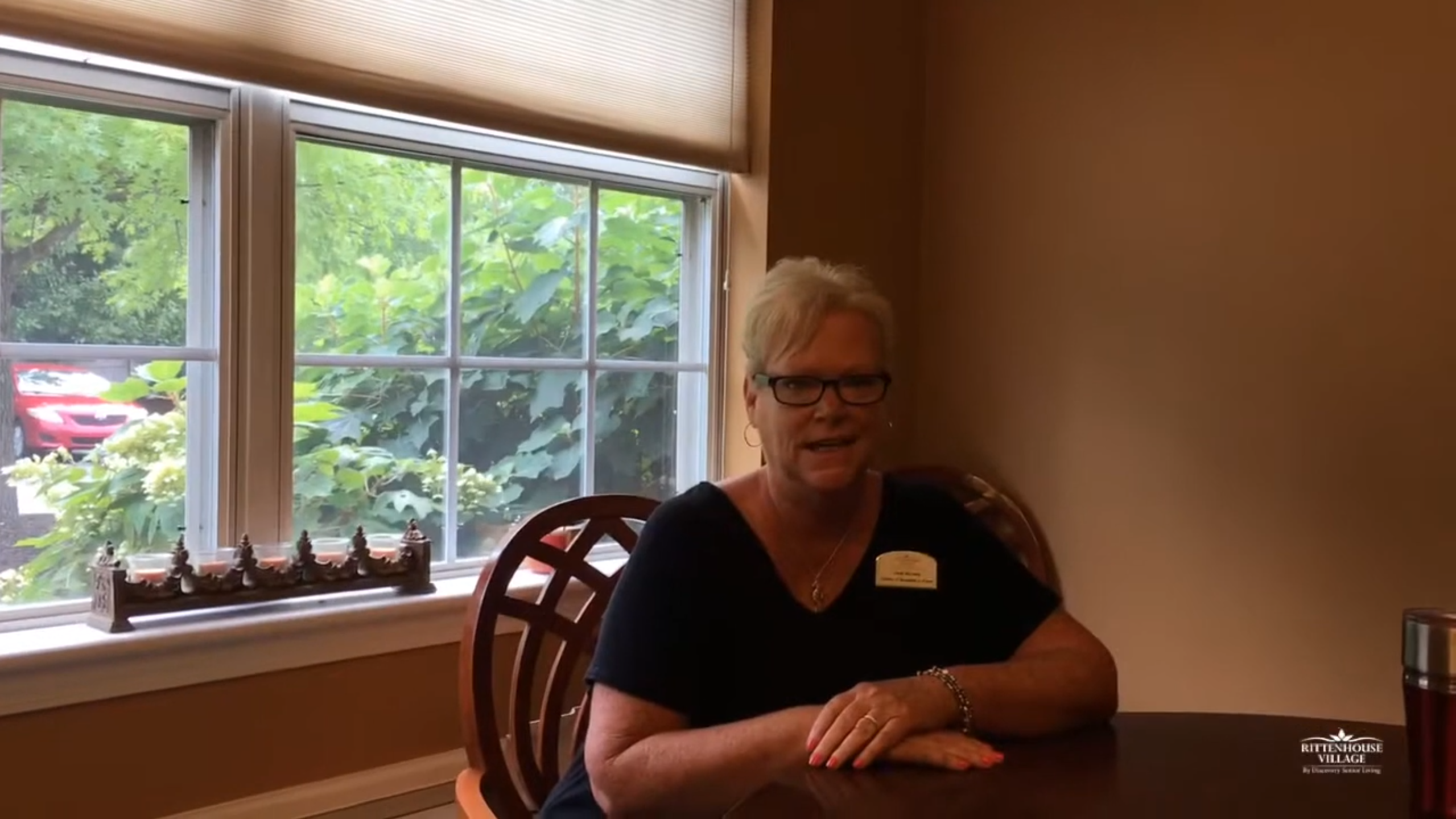 A staff member sitting in a well-lit room