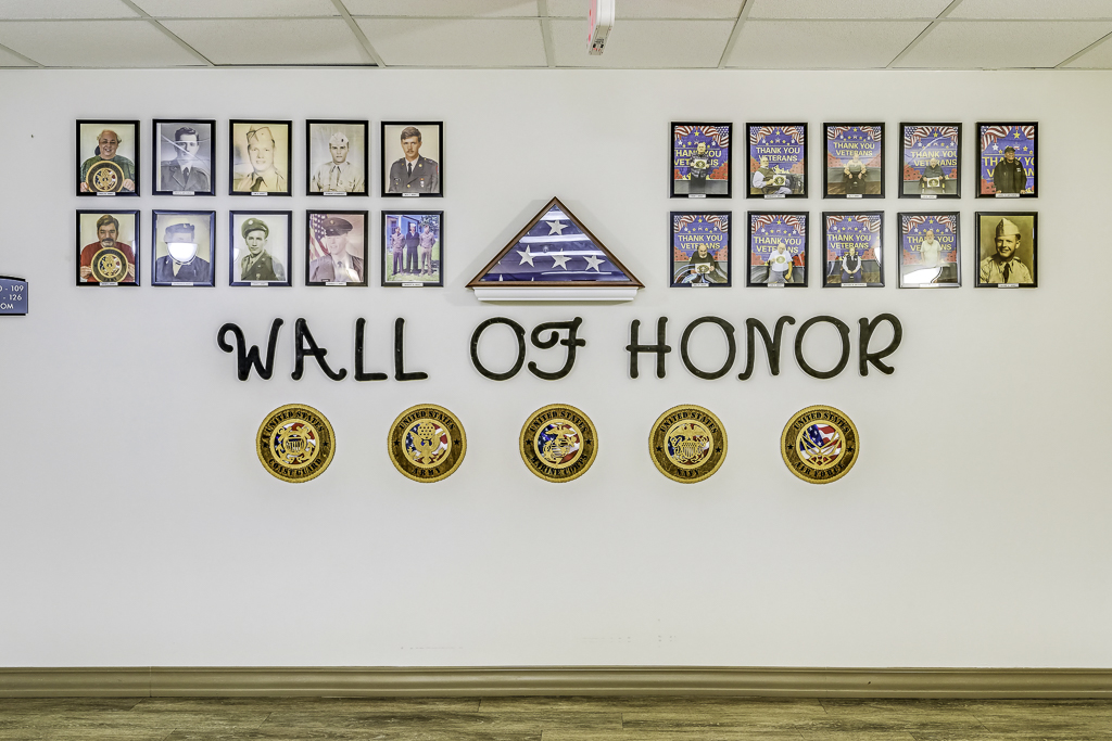 Wall of honor displaying photos and awards
