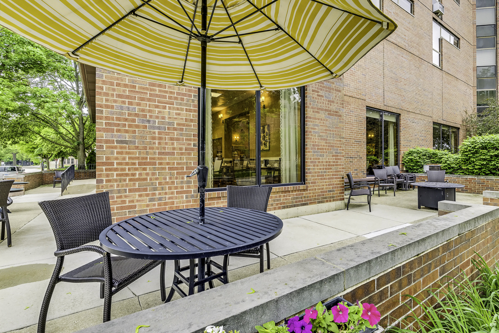 Outdoor seating area with flowers and building facade