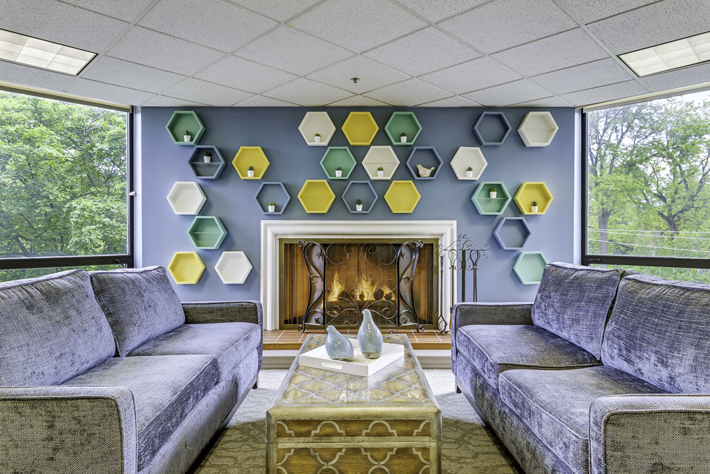 Comfortable seating area with decorative wall and fireplace