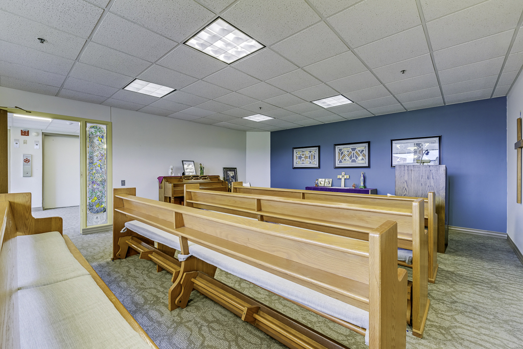 Interior view of a common area with wooden benches