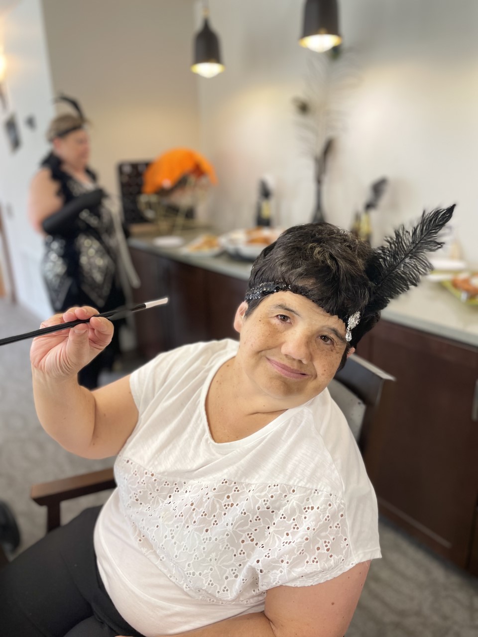 Resident participating in a themed activity with food nearby