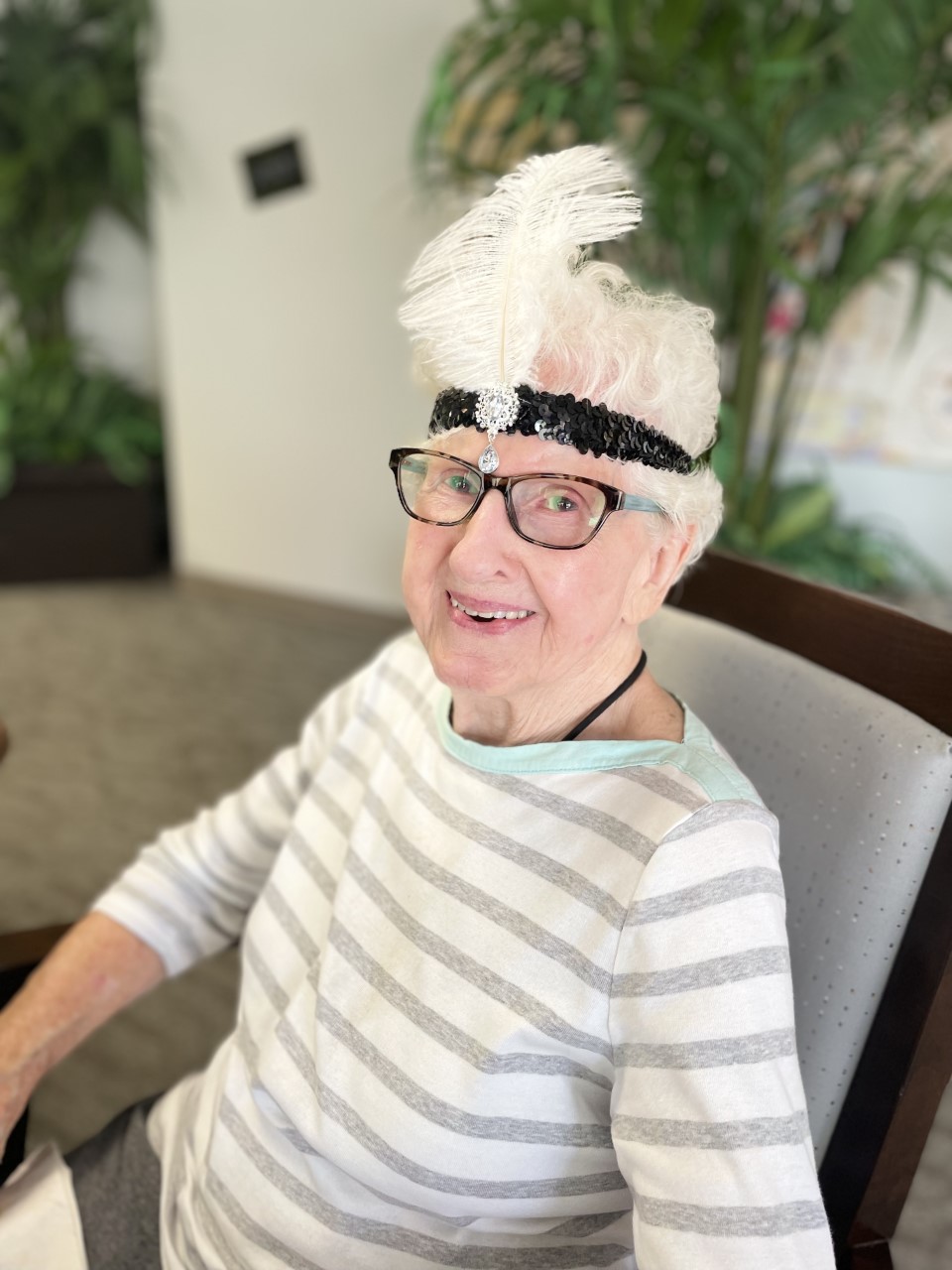 Resident wearing a festive headband in the common area