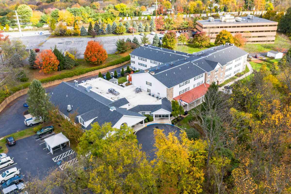 Aerial view of the facility surrounded by autumn foliage